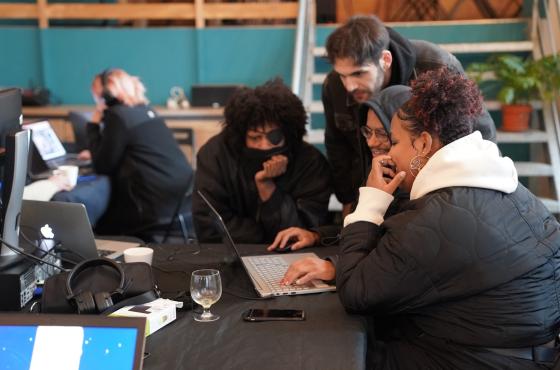 Workshop participants watching a game together on a laptop.